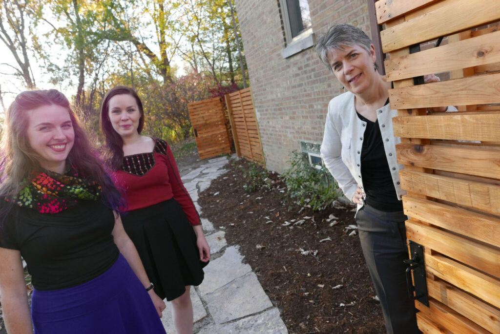 McAlpine staffers smile in a sunny backyard